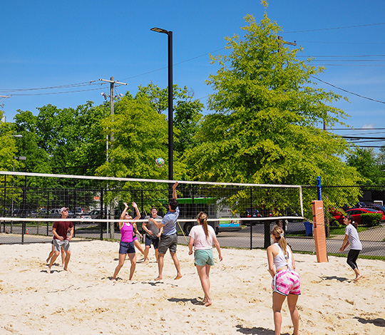 Students playing volleyball on campus